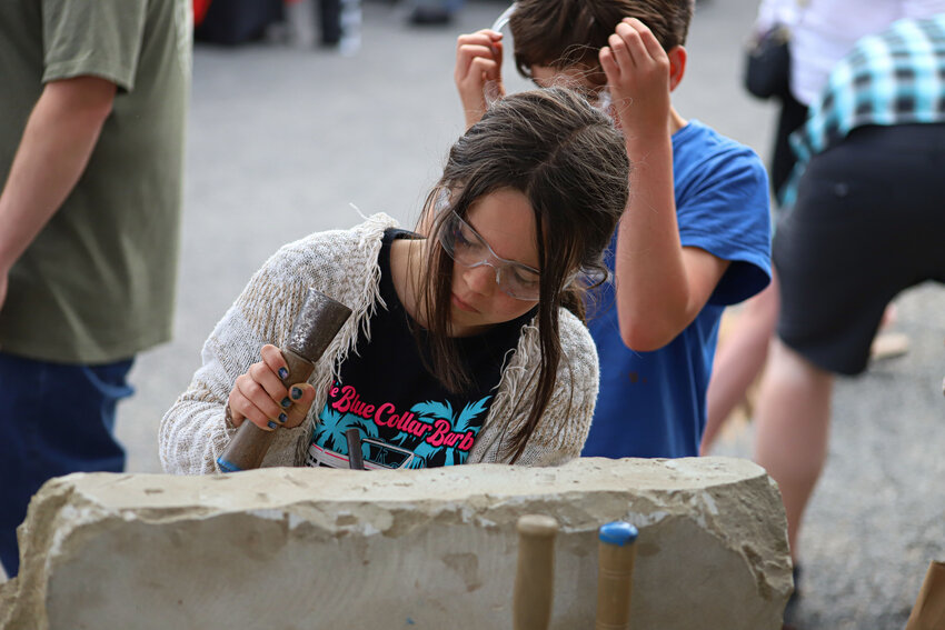Keith Phillips of the Tenino Stone Carvers works on a piece at the Tenino Stone City Arts Festival on Saturday, June 14.