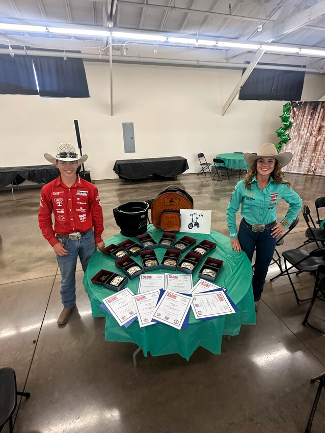 Jace Harris, left, and Brooklynn Bell, right, pose for a photo with their awards from the Washington State Junior High Rodeo Finals and Year-End Banquet.