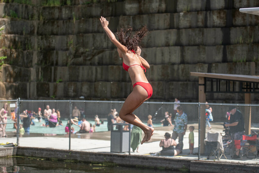 Swimmers leap from diving boards at the newly reopened quarry pool during Tenino Family Fun Day held at Tenino City Park on Saturday, June 22.