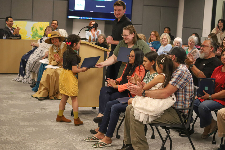 Coya Mauger receives a people's choice award for her Thurston County Art Contest submission &quot;Sunless Sunflower&quot; at the Thurston County Board of County Commissioners meeting at The Atrium on Tuesday, June 17.