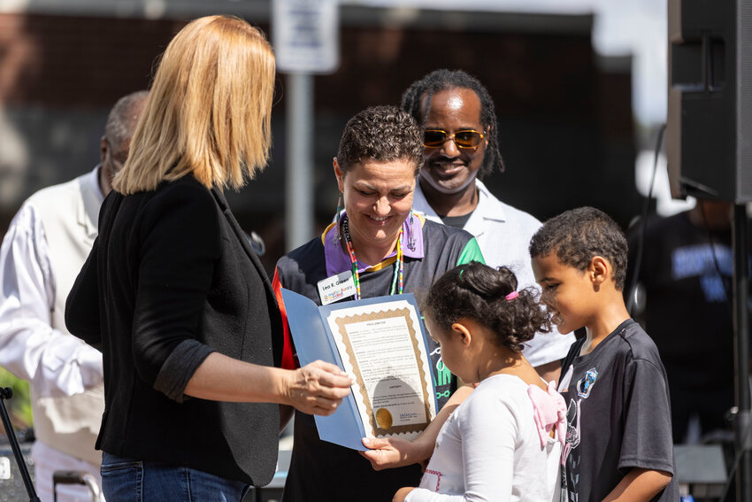Lea Green and her family, of Multiculturally Minded Lewis County, accepts a proclamation from Mayor Kelly Smith Johnston during a Juneteenth celebration at George Washington Park in Centralia on Thursday, June 19.
