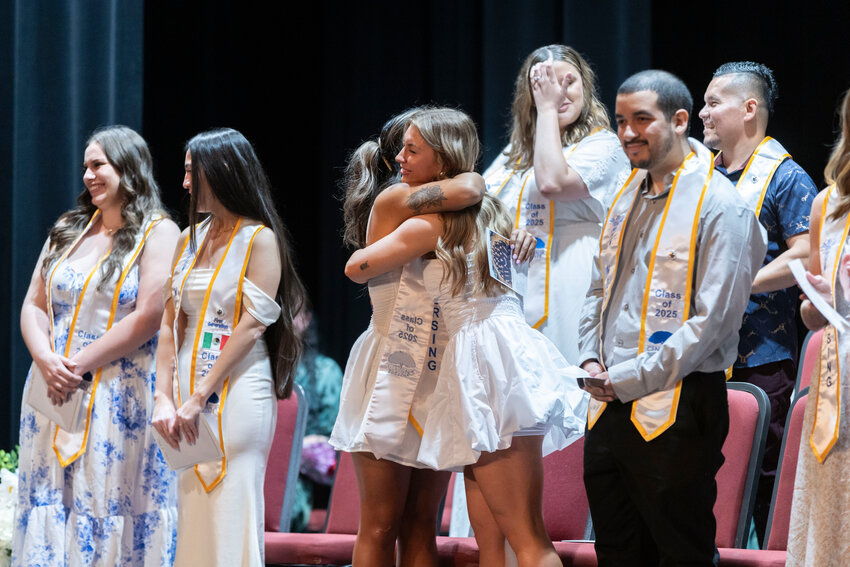 Nursing school graduates embrace at the end of the Centralia College class of 2025 Nursing Pinning Ceremony at the Corbet Theatre on Friday, June 20.