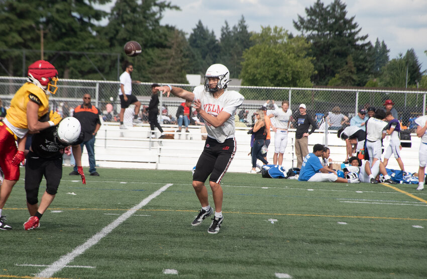 Yelm athlete Quinten Loomis breaks a tackle during a spring scrimmage against Sumner at Pacific Lutheran University on Thursday, June 19.