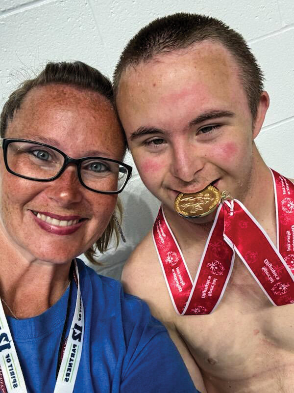 Chandra and Hezekiah Hewes celebrate Hezekiah&rsquo;s gold medal at the Washington State Special Olympics State Swimming Championships in Federal Way on Saturday, June 21.
