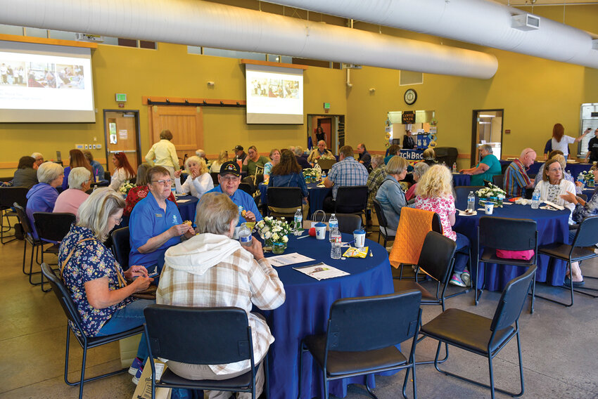 Guests gather at the Battle Ground Event Center for Battle Ground Senior Citizens Inc.'s 50th anniversary celebration on Monday, June 23. Projections displayed throughout the venue told the story of the organization's evolution since 1975.
