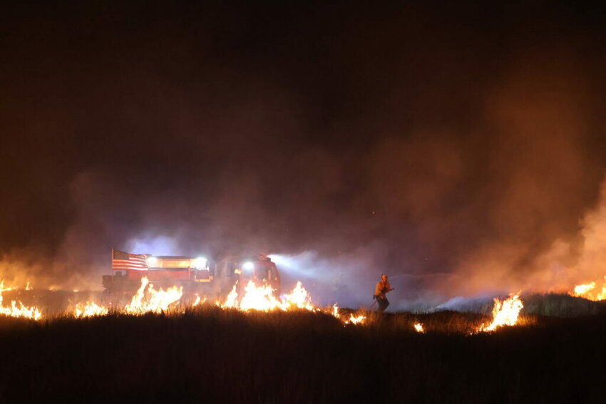 Ocean Shores firefighters respond to a dune grass fire on the Fourth of July in 2024.