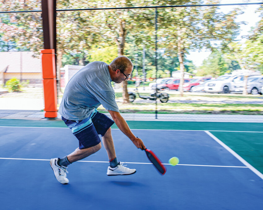 Jaren Ek returns the ball during a friendly match of pickleball with Steve Lyon on Wednesday, July 2, at the newly opened pickleball courts at Kiwanis Park in Battle Ground.