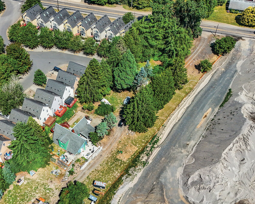 Joe Listek, of Woodland, has found himself between a rock and a hard place. On one side, a rowhouse development's gutter runoff has caused a hole to appear on his property, which gurgles up raw sewage. Additionally, a leaking fire hydrant spews water from underground onto his land. On the other hand, the Lewis River Subdivision project has him concerned that their floodplain storage plan will fail and run onto his property in a similar fashion to the 1996 flood.