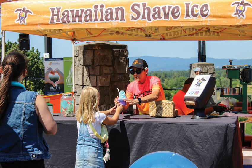 Locals gather at Overlook Park while enjoying free Honu Shave Ice during Main Street Day 2024. The annual celebration returns Friday, July 11, from 11 a.m. to 2 p.m. with live music, dancing and community activities downtown.