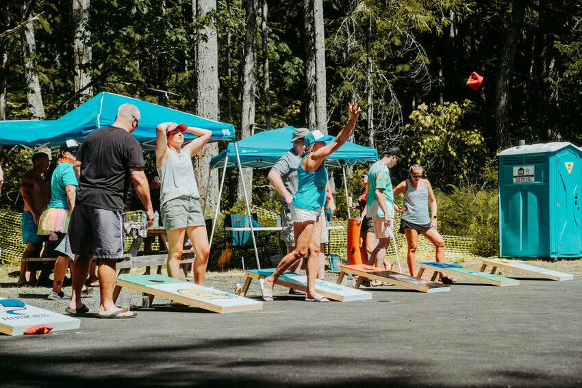 Participants in the 2023 Sally Strong Summer Event compete in the cornhole tournament.