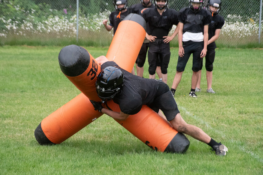 Rainier head coach Andy Bartell instructs his team during a practice at Rainier Elementary School on July 2.