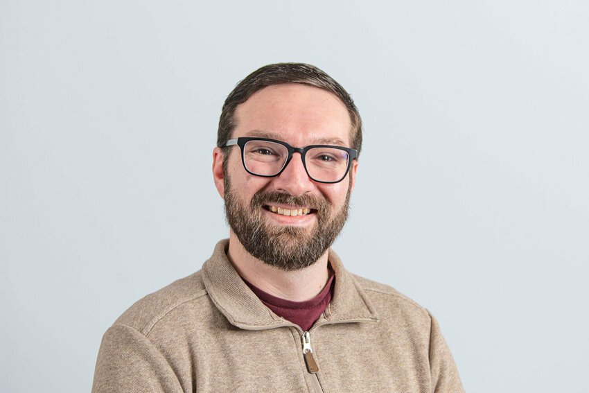 Lewis County Democrats Chairman Zachary Eckstein smiles for a portrait at The Chronicle&rsquo;s Centralia office on Thursday, Dec. 26.