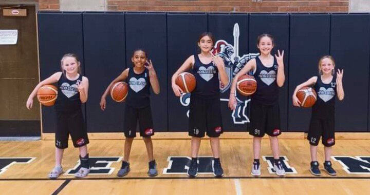 All five members of the NyaStrong Warriors Academy basketball program pose for a photo.