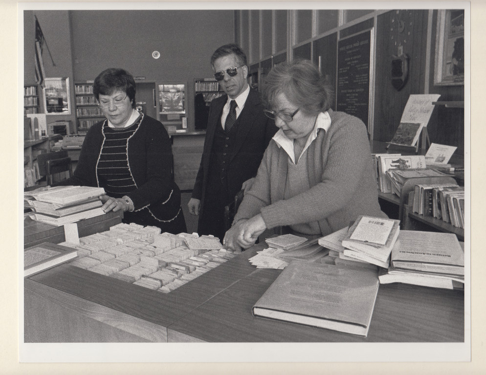 Former Library Director Marshall Botwinick with clerks Florence Facibene, left, and Rose-Mary Striffolino at the circulation desk in 1983.