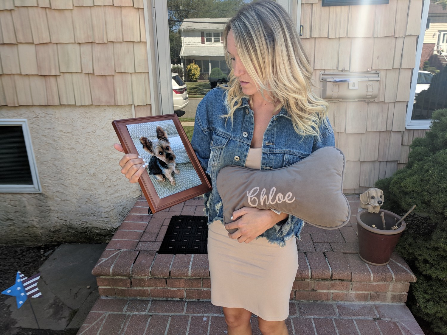 Chelsea Mann of Oceanside with a photo of her Yorkshire terrier, Chloe, who was allegedly mauled to death by her neighbor’s pit bull two weeks ago, along with Chloe’s favorite pillow.