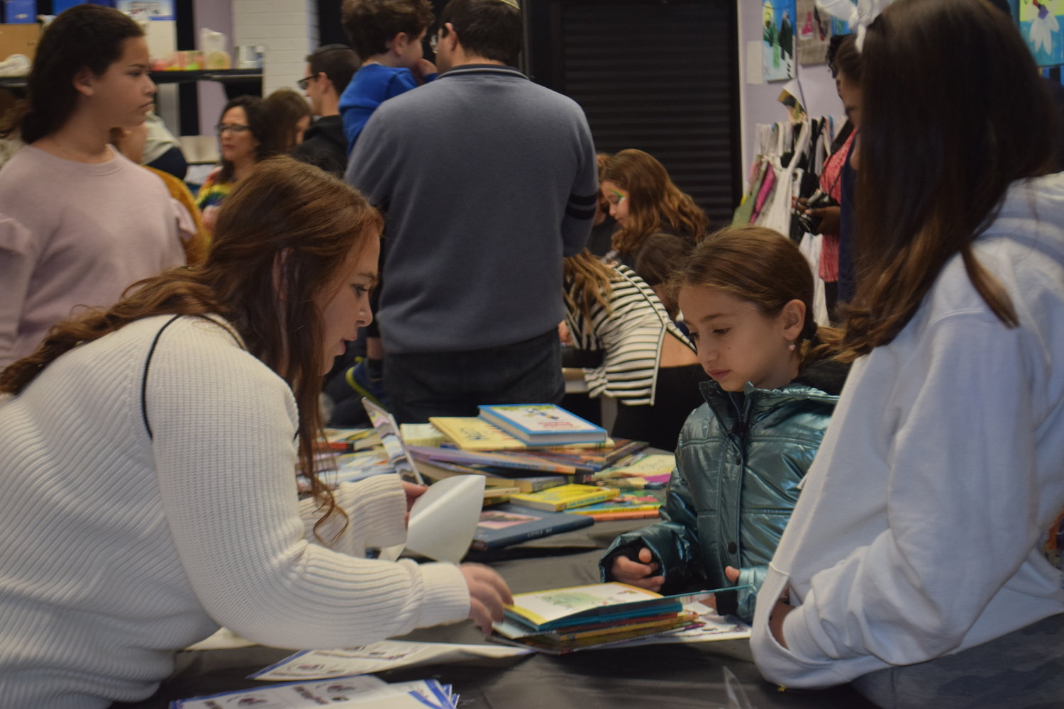Volunteer Makayla Schein assisted with choosing books at the book fest.