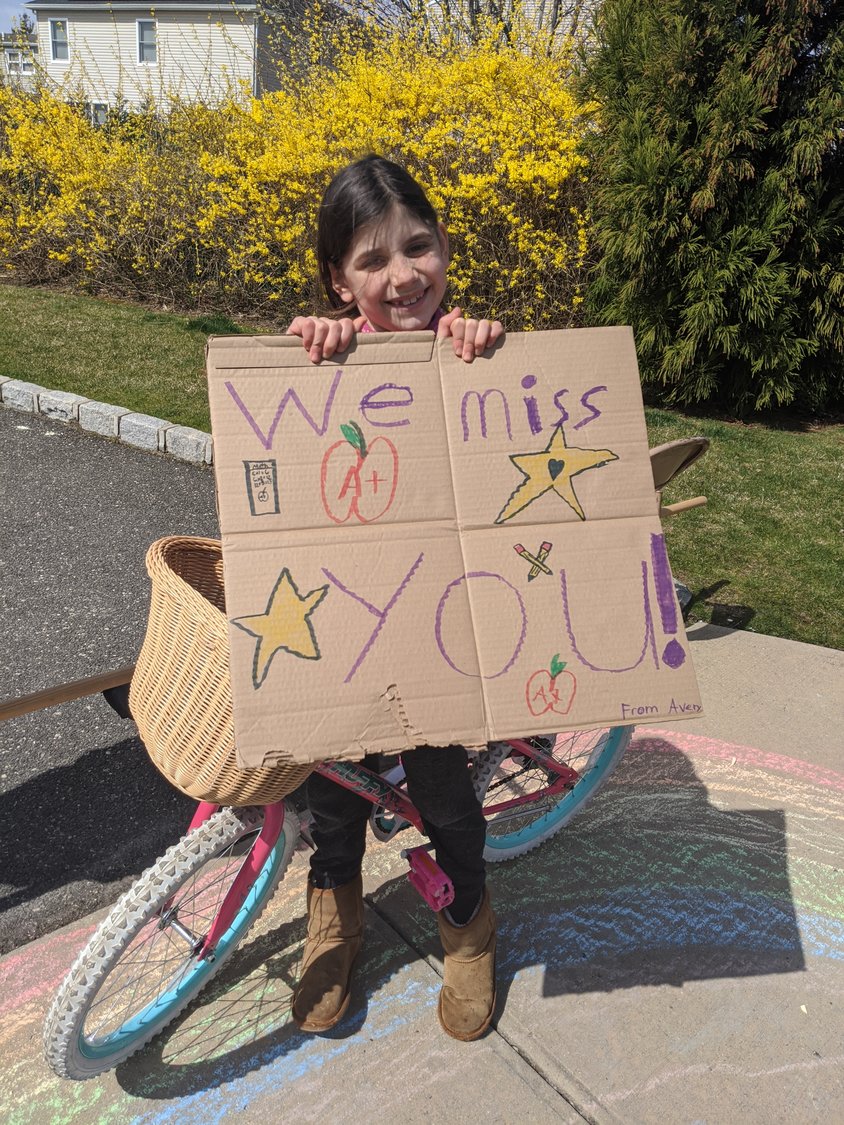 Avery LoCascio, a third-grader at Winthrop Avenue School, created a cardboard sign and drew a rainbow on the sidewalk to show appreciation for her teachers.