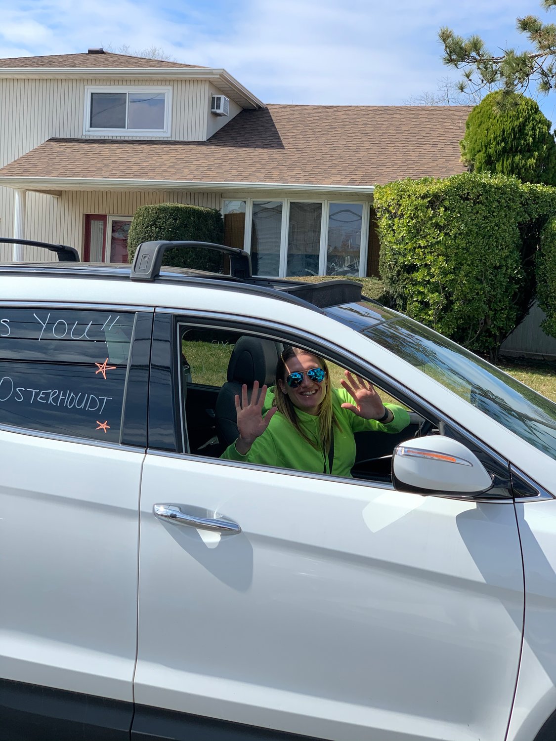 Shore Road School fifth-grade teacher Nicole Osterhoudt waved to her students from the safety of her car.