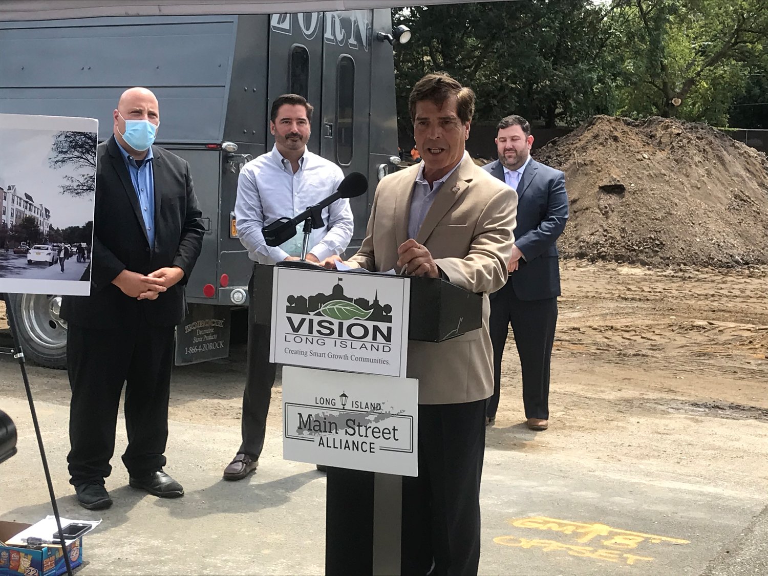 Lynbrook Mayor Alan Beach, at lecturn, and developer Anthony Bartone were presented with Smart Growth Awards from Vision Long Island on Aug. 6 for the forthcoming Cornerstone at Yorkshire project. Beach spoke about the importance of the project.