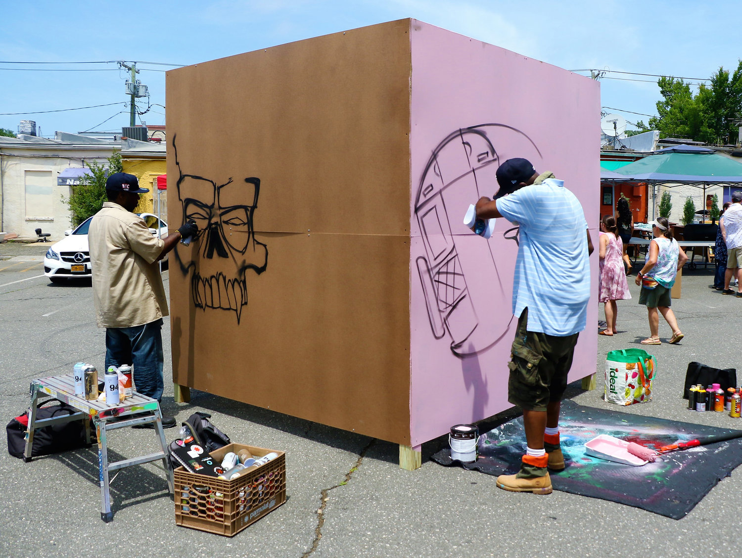 James Enuf Rufffin started painting his creation of a skull and Lou Defour started painting his artwork of a train during the live mural painting event.
