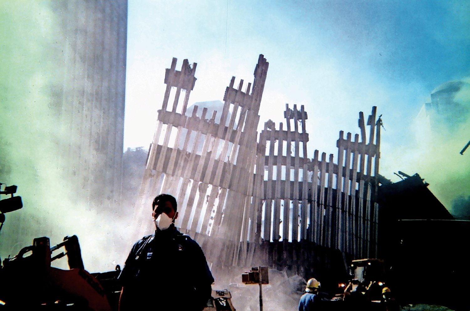 Member Ed Chasan against a harrowing backdrop of a collapsed tower.