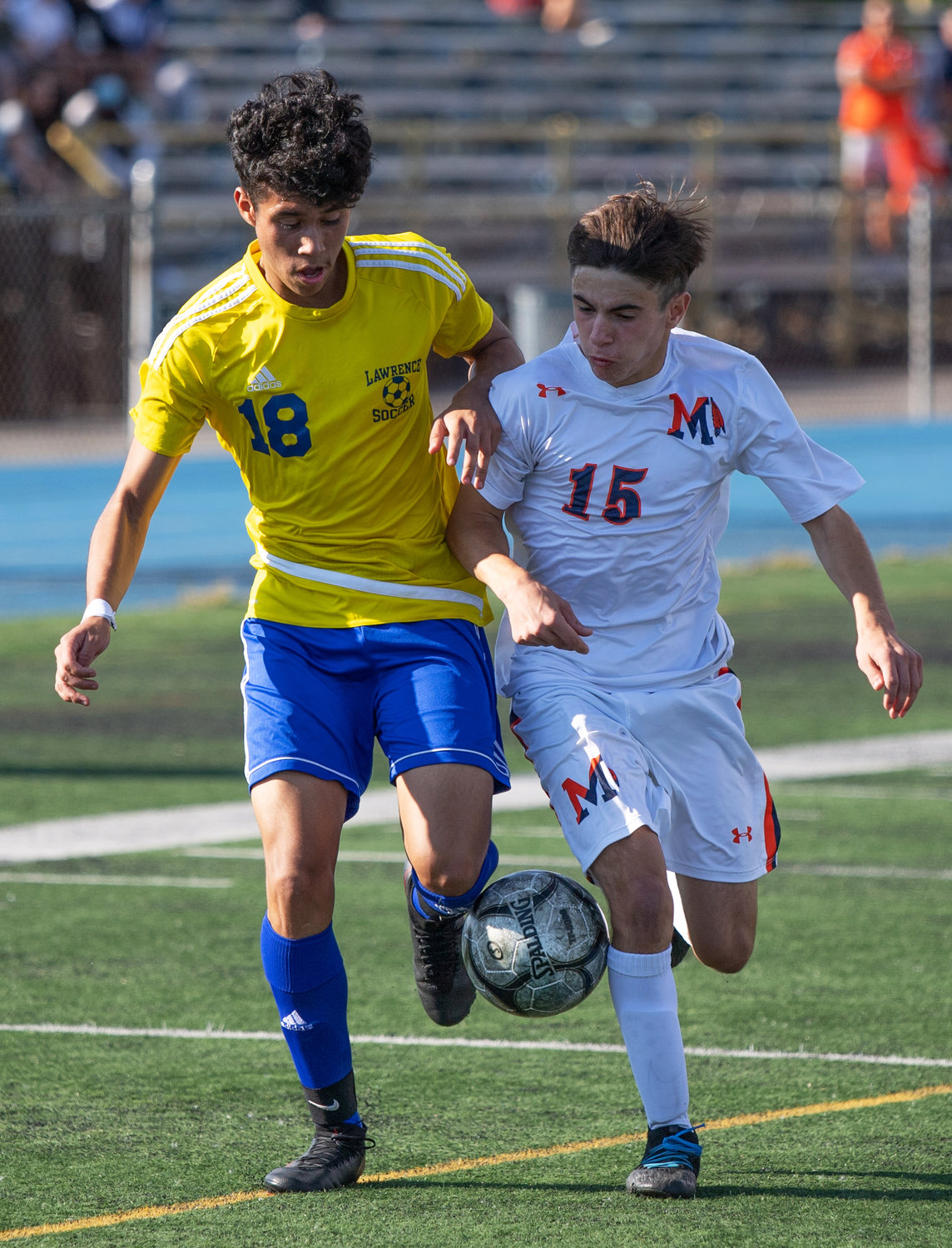 Lawrnce's Jessi Vasquez, left, and Manhasset's Gianluca Milazzo battled for control of the ball during last Friday's Nassau Class A playoff matchup.