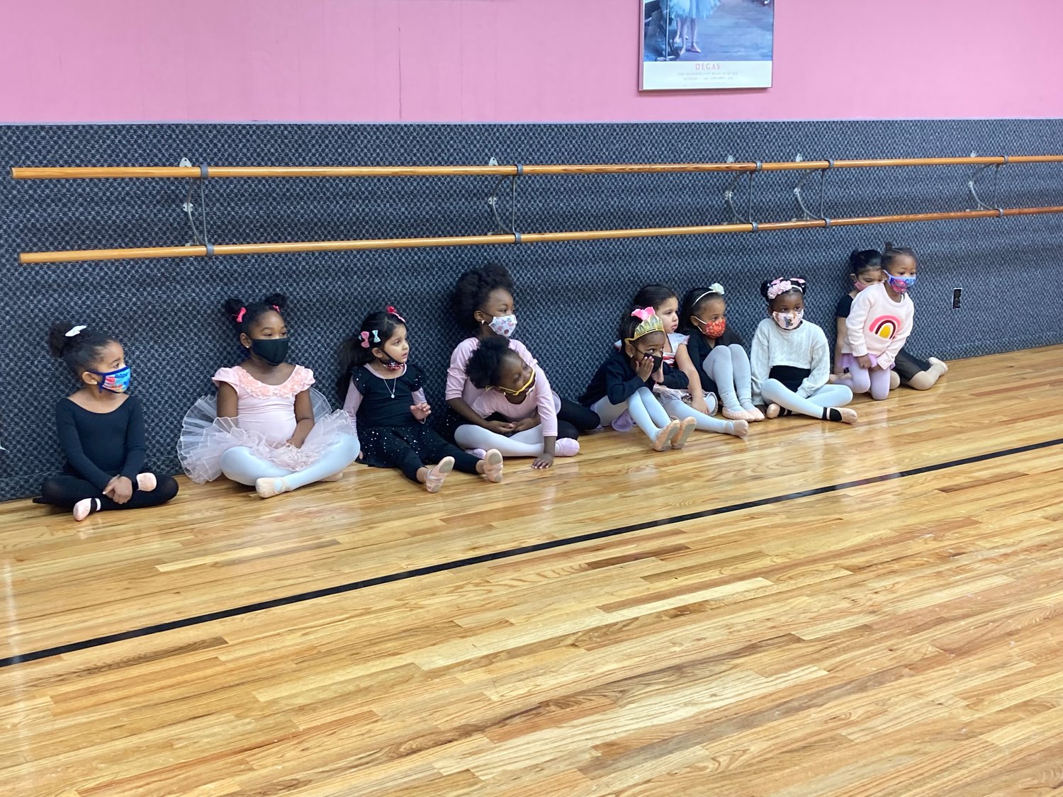 Two- to five-year-old girls line up waiting for their creative dance class to start.