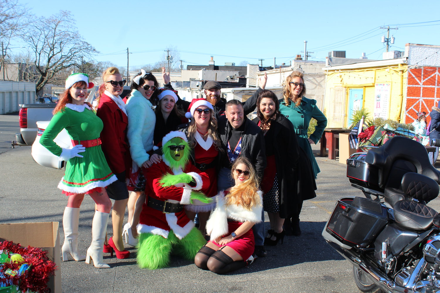 The grinch road in on his motorcycle to spread cheer with the Rescue Vixens, Shawn Sabel, center, and Steven Burke, third from right.