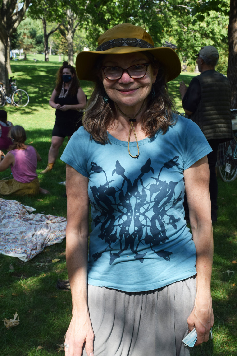 Returning artist and former BareBones Board Member Marian Lucas attends the community gathering at Powderhorn Park. "It's been hard being the only deaf person, but people make me feel welcome. We try to communicate. We can create life together. It's been a fun experience for me." (Photo by Jill Boogren)