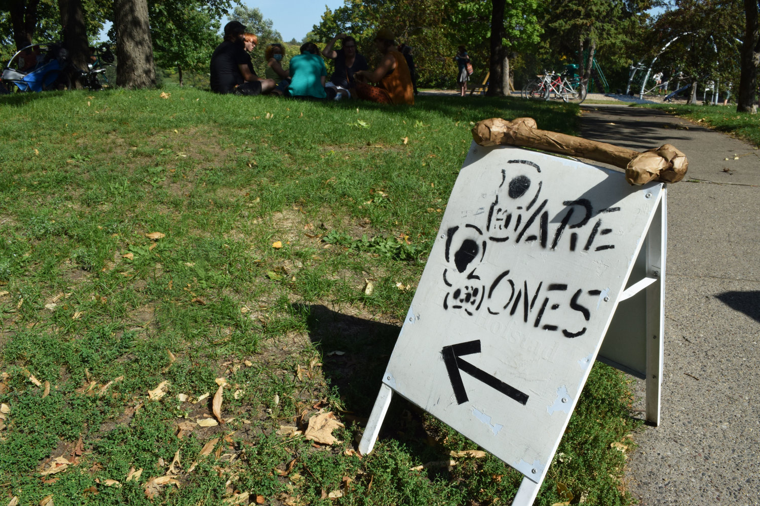 Sign points the way to a Bare Bones community gathering at Powderhorn Park. (Photo by Jill Boogren)