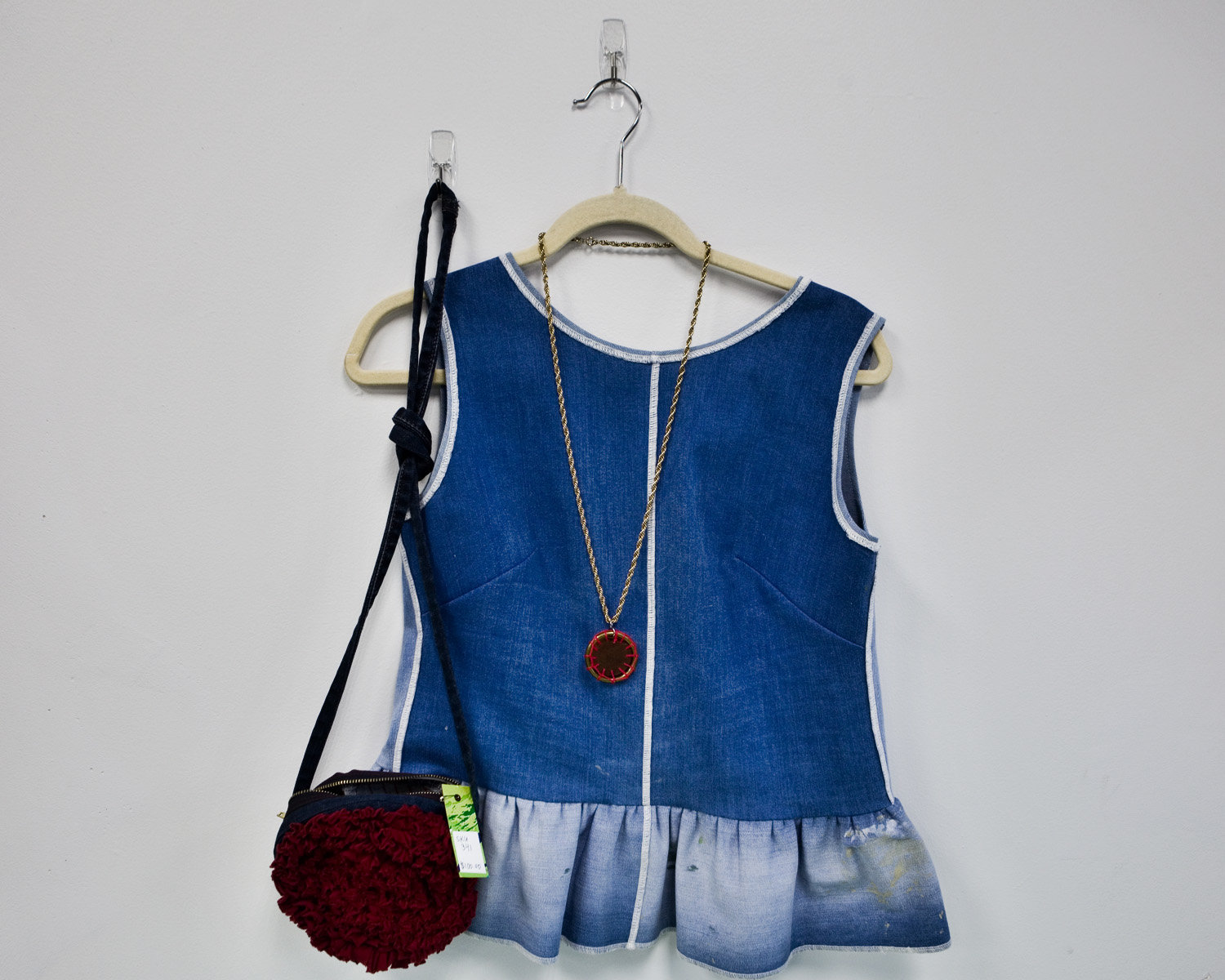 Examples of upcycled clothing for sale at the shop.