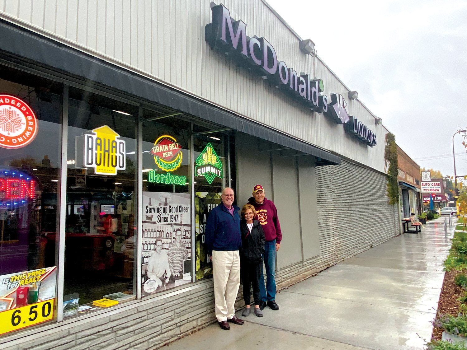 Bob Albrecht (left) stands with Janet and Lee Nelson outside McDonald's Liquor store along 34th Ave. Albrecht currently lives and works from home in the house Janet's dad built along Shoreview Ave. Lester Strom was a self-employed home-builder whose firm, Strom & Mayville, constructed many single-family homes, apartments and duplexes in the Nokomis East neighborhood.