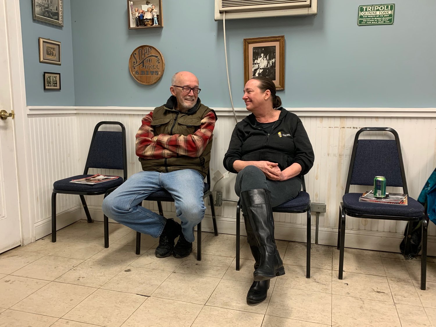 Barber Kristin Ohnstad (right) became the proprietor of Bob’s Barber Shop when her father, Bob, retired 11 years ago. She is selling to move out west. (Photo by Sue Filbin)