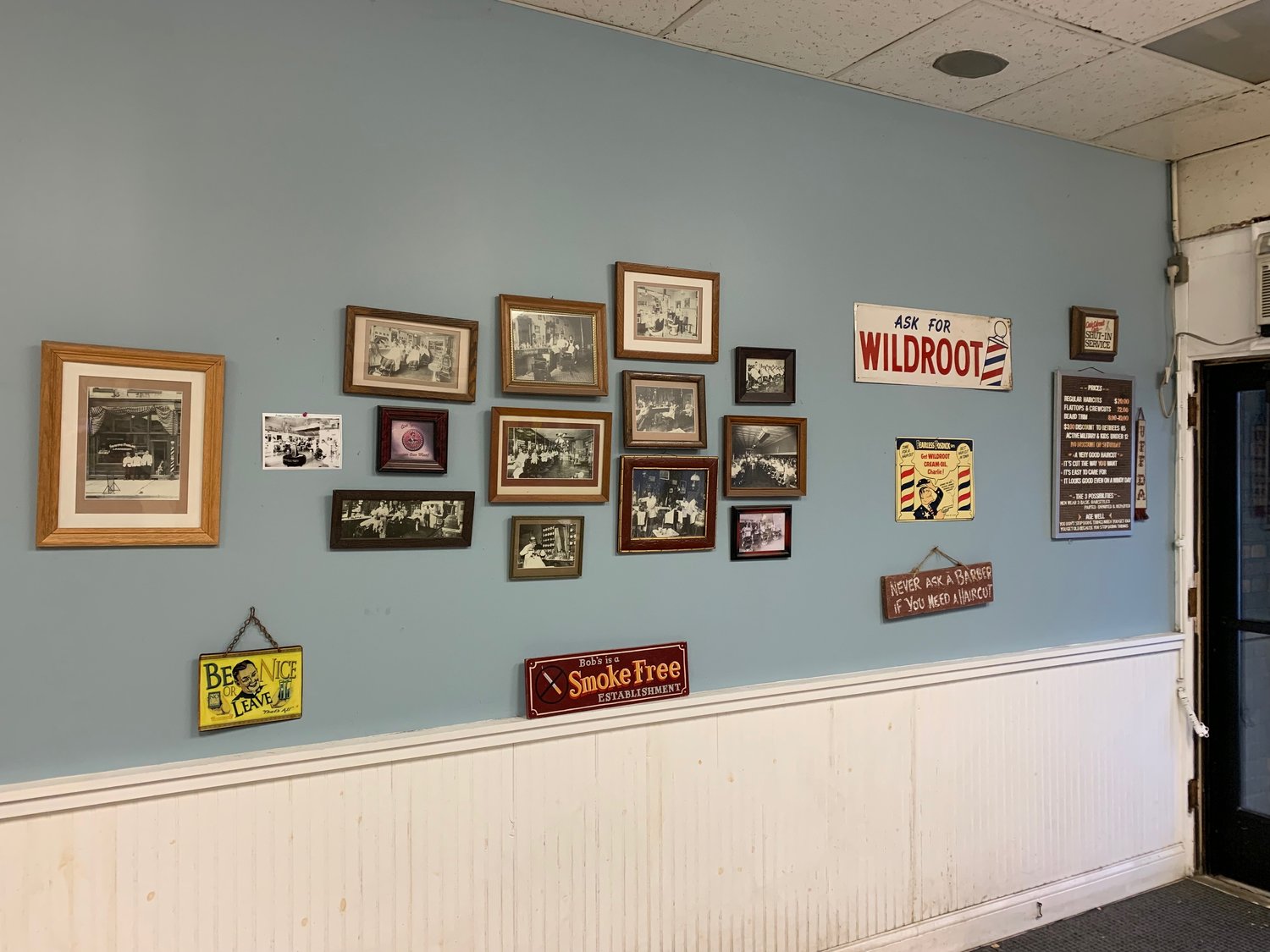 A photo history of barbering is displayed on one wall of 94-year-old Bob’s Barber Shop.