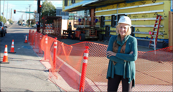 Susan Haigh, President and CEO of Twin Cities Habitat for Humanity, in front of their new headquarters under construction at University Ave. and Prior Ave. in St. Paul. Their new building is expected to be finished this January. (Photo by Jill Boogren)