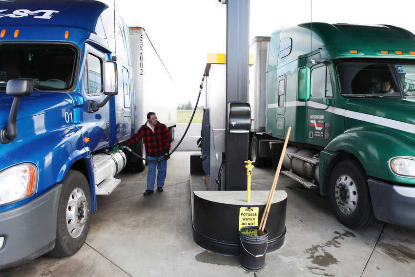 KSI truck driver Jose Romero fills up his truck at the Love's gas station in Napavine on his way toward Los Angeles Monday.