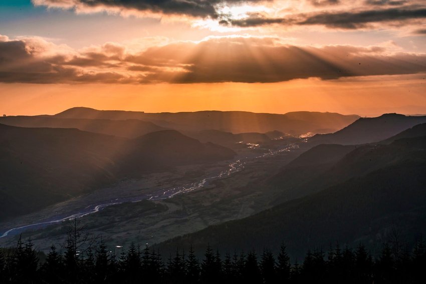 Sun shines down on the North Fork Toutle River and foothills of Mount St. Helens in 2021.