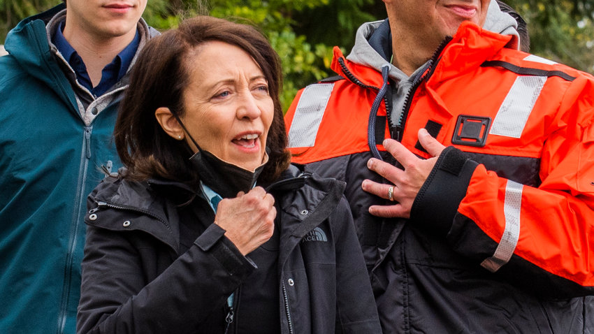 U.S. Senator Maria Cantwell lowers her mask as she is greeted before touring the Nisqually River by boat in April 2022.
