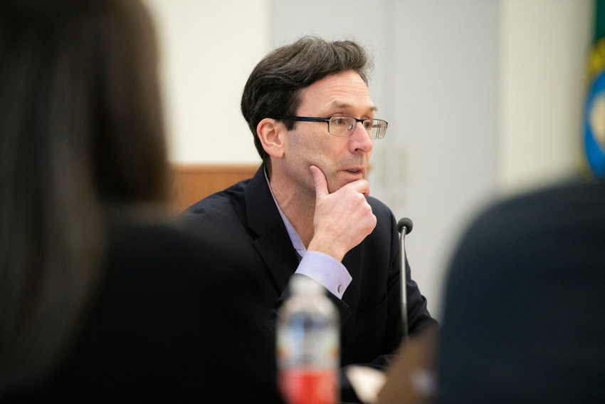 Attorney General Bob Ferguson talks to members of the press during a legislative meeting inside the John A. Cherberg building in Olympia on Thursday.