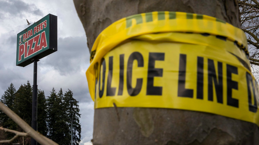 Police tape wraps around trees at the former location of Papa Pete&rsquo;s and Shari&rsquo;s Cafe in Centralia on Tuesday after a fire consumed the structure.