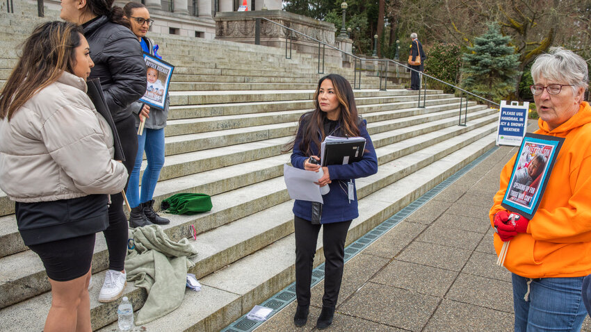 Senator Nikki Torres, a former Pasco City Council member, talks to demonstrators outside the Washington State Capitol building in Olympia for Child Abuse Prevention Month during an event organized by the family of Hazel Journey on Sunday, April 23, 2023.