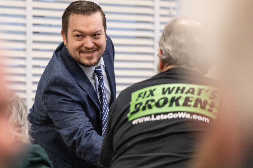 Rep. Travis Couture shakes a person&rsquo;s hand during a public hearing on an initiative regarding parental rights in Olympia on Wednesday, Feb. 28, 2024.