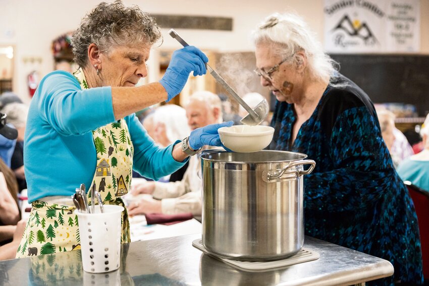 Linda Farr serves clam chowder at the Rainier Senior Center on Wednesday, April 10, 2024.