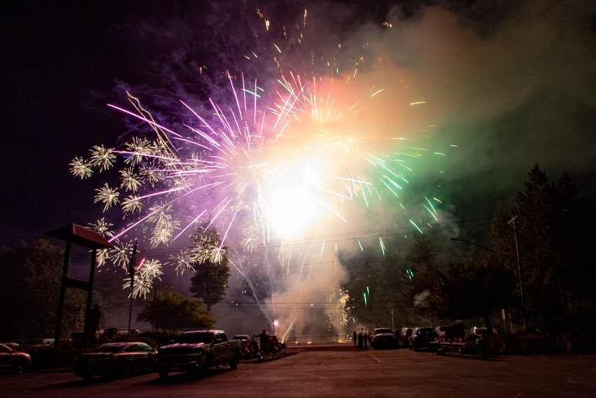 Purple, yellow and green colors fill the sky on Saturday, July 6, 2024, as fireworks burst during Packwood's Independence Day fireworks show finale in a show organized by Lewis County Fire District 10 Chief Lonnie Goble.