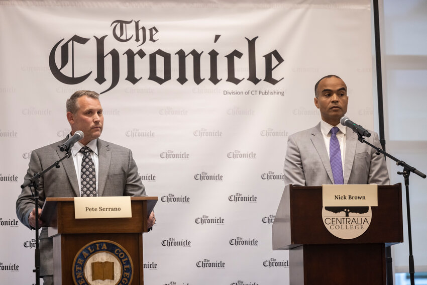 Pasco Mayor Pete Serrano, left, and former U.S. attorney for Western Washington and current state Attorney General Nick Brown listen to a question during a debate hosted by The Chronicle in the TransAlta Commons at Centralia College on Thursday, Sept. 26.