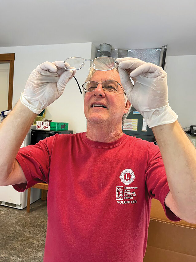 Battle Ground Lions Club member Steve Staudinger inspects a pair of donated eyeglasses that will be sorted and sent to Northwest Lions Eyeglass Recycling Center.