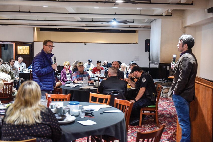 Woodland Mayor Todd Dinehart (left) speaks to Third Congressional District candidate Joe Kent during a local forum. Dinehart asked the candidate how the federal government could be more involved in city efforts to address homelessness.