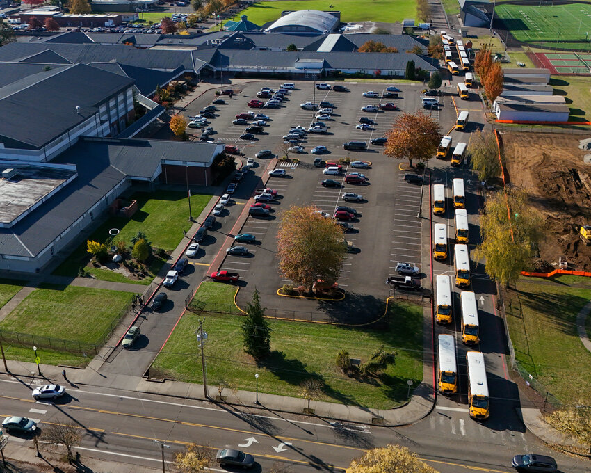 A fleet of buses and students with their own vehicles leave Battle Ground High School on Thursday, Oct. 24, as the school day ends.