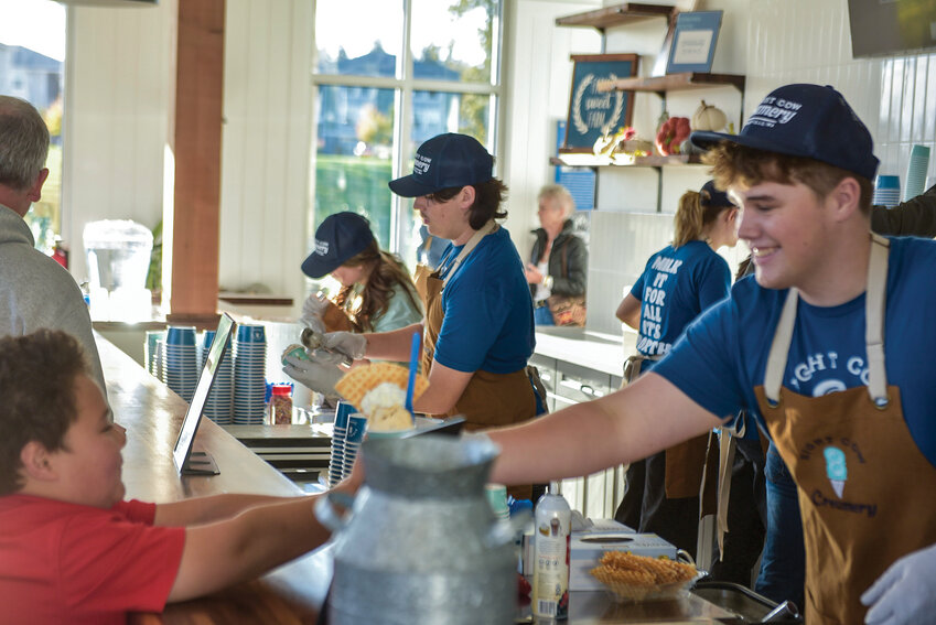 Eight Cow Creamery workers handed free samples to visitors during its pre-opening celebration on Tuesday, Oct. 22.