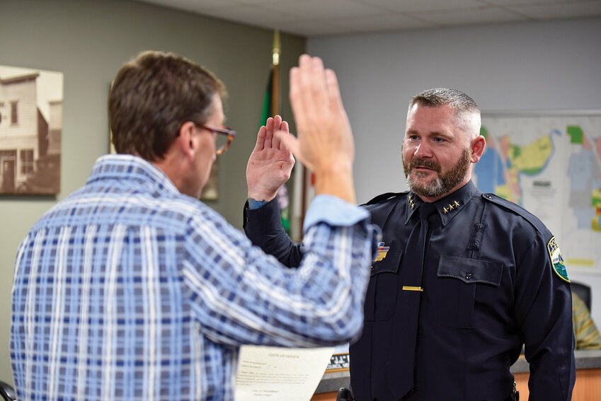 Robert Gibbs takes the oath of office as Woodland's new police chief during a packed City Council meeting on Monday, Oct. 21. The new chief's priority is to fill two vacant patrol positions.